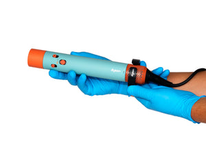 Two hands in nitrile gloves cleaning a Dyson Airwrap filter with a brush